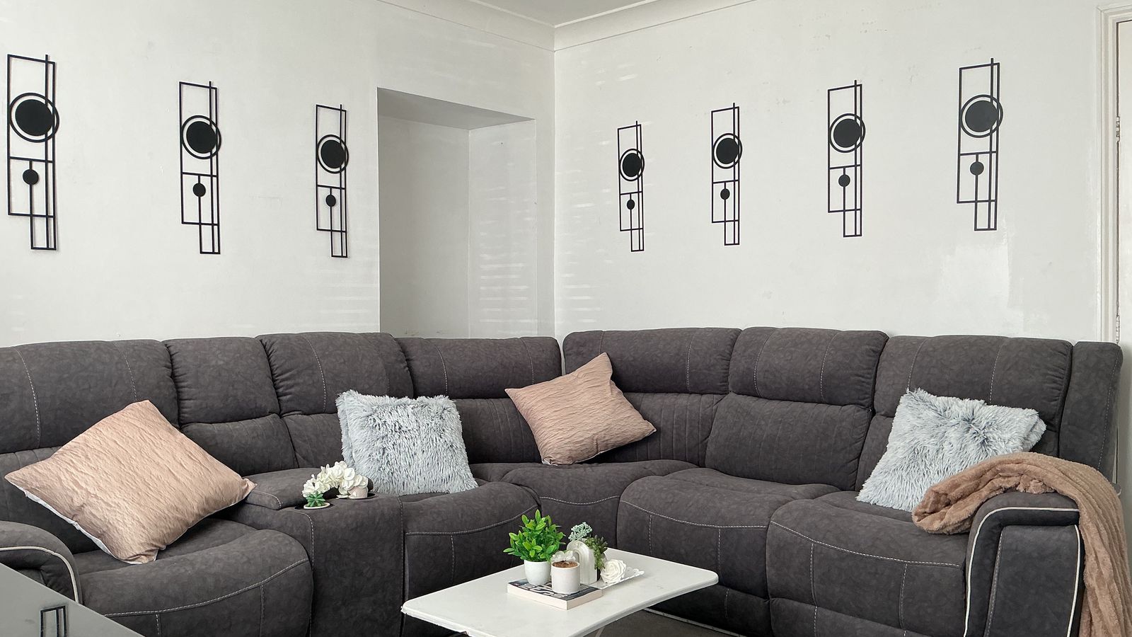 The same living room after Alangrim, with wall panels, cushions and a coffee table